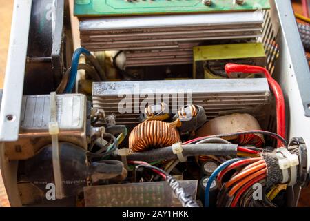 Old and dusty computer power supply during cleaning. Stock Photo