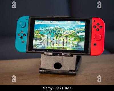 UK - Feb 2020:Nintendo switch games console with Fortnite game playing on screen Stock Photo