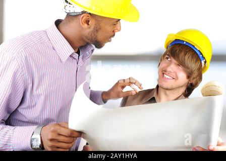 Young engineers in office talking Stock Photo