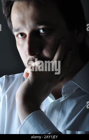 Young man smiling in the dark Stock Photo