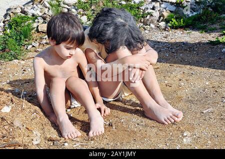 Poverty and poorness on the expression of children Stock Photo