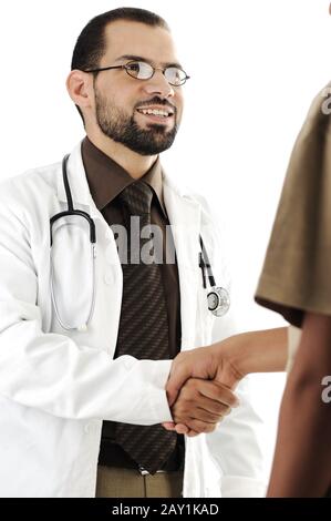 Young adult doctor shaking hand of patient and smiling Stock Photo