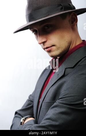 Elegant young man with a hat looking at camera Stock Photo