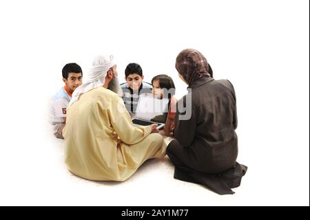 Teacher with children using laptop Stock Photo