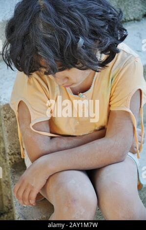 Poverty and poorness on the expression of children Stock Photo