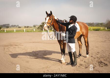 Man caressing his horse before dressage horse jumping event Stock Photo
