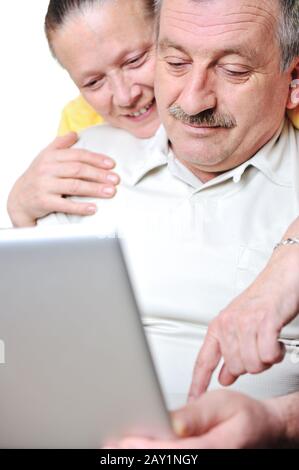 Portrait of elderly man and woman working on laptop Stock Photo