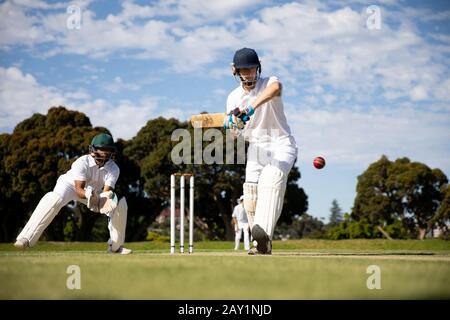 Cricket player shooting in the ball Stock Photo