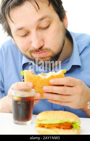 Handsome man enjoying burger and coke Stock Photo
