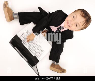 Business kid wearing suit with laptop Stock Photo