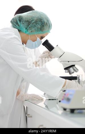 Working in lab with microscope Stock Photo