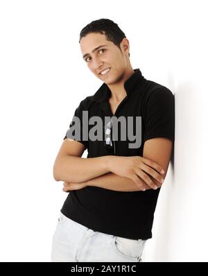 Closeup photo of a middle eastern guy standing against the wall with folded arms isolated Stock Photo