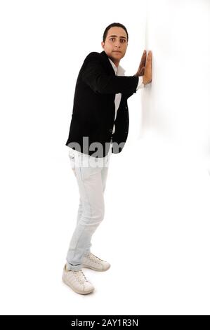 Full body of an arabic student leaning against the wall isolated Stock Photo