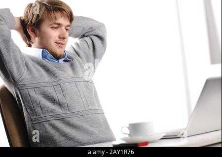 Relaxed young man in office Stock Photo