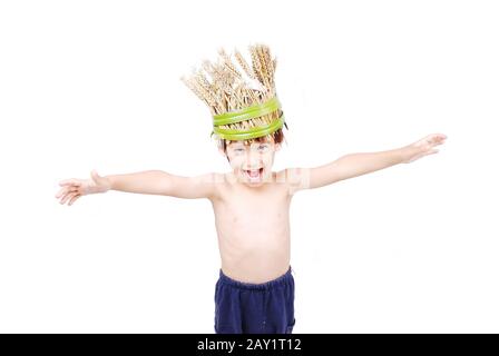 Cute kid with wheat hat on head with hands up Stock Photo