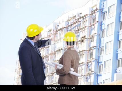 Two young engineers with blueprints Stock Photo