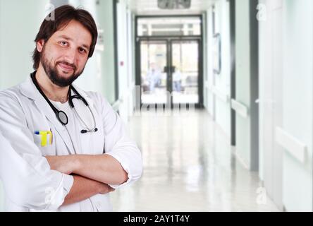 Young positive doctor on his workplace Stock Photo
