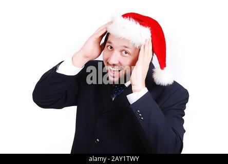 Young male model in suit with santa hat on head Stock Photo