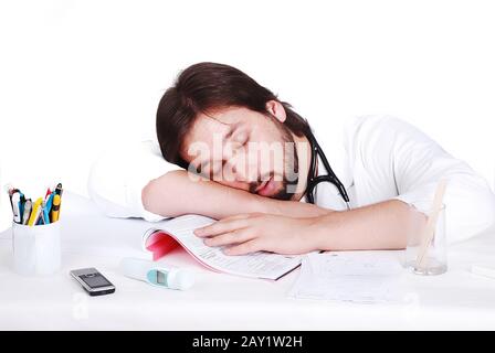 Young male doctor is sleeping on his desk in office Stock Photo