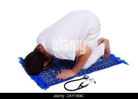 Male muslim doctor is praying Stock Photo