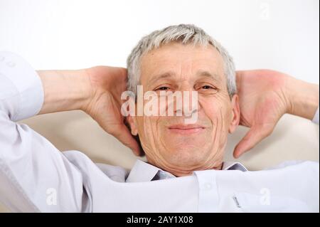 Happy relaxed elderly man at home Stock Photo