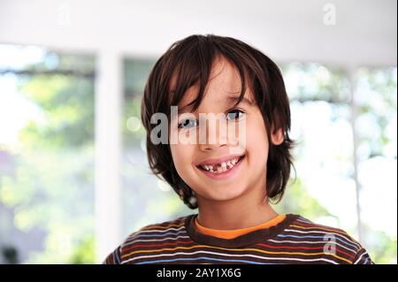 Happy cute boy without front tooth, prepared for the school Stock Photo