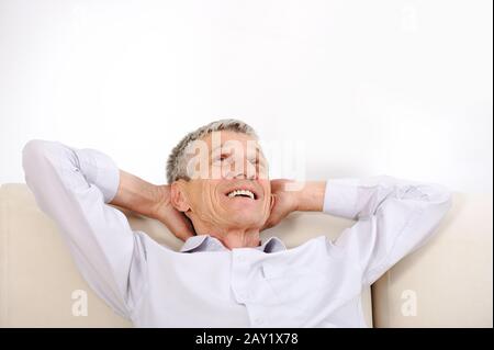 Happy relaxed elderly man at home Stock Photo