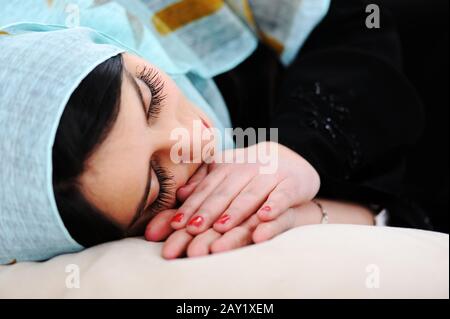 Arabic woman sleeping on sofa Stock Photo