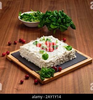 Vegan pie with cream cheese, tomato, basil and cranberry Stock Photo