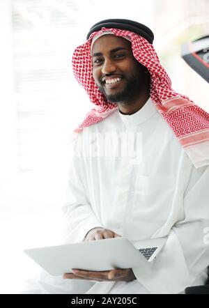 Black Arabic man working on laptop Stock Photo