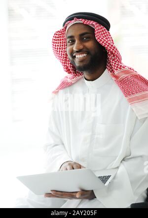 Black Arabic man working on laptop Stock Photo
