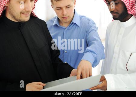 A business team of three planning work in office Stock Photo