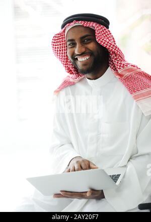 Black Arabic man working on laptop Stock Photo