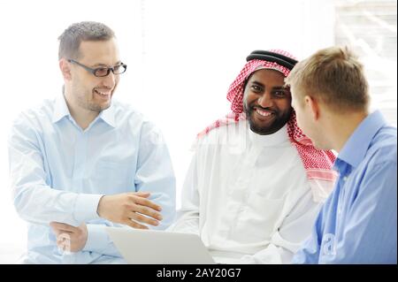 Multicultural different ethnic group working on laptop together Stock Photo