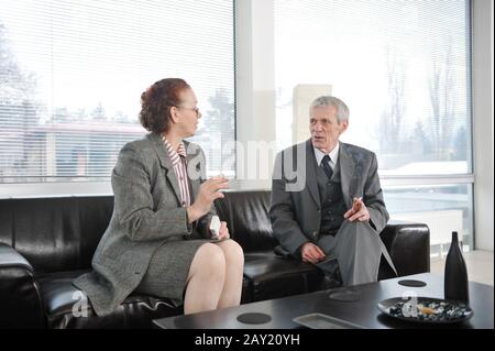 Two colleagues having a break during business meeting with cigarette Stock Photo