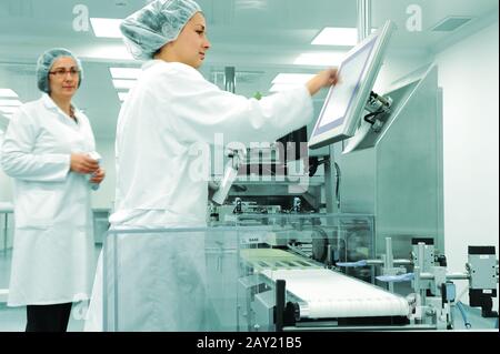 Working people at  production line in modern factory Stock Photo
