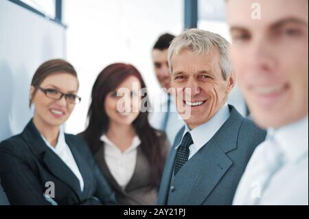 Small business team in the office in front of a whiteboard Stock Photo