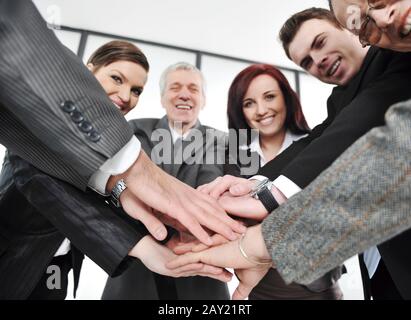 Group of executives placing their hands together Stock Photo