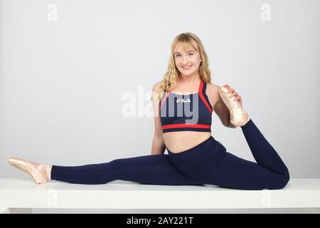 Female ballet dancer photographed in the studio doing the splits Stock Photo