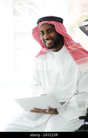 Black Arabic man working on laptop Stock Photo