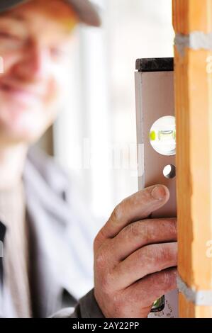 Construction worker with level tool Stock Photo