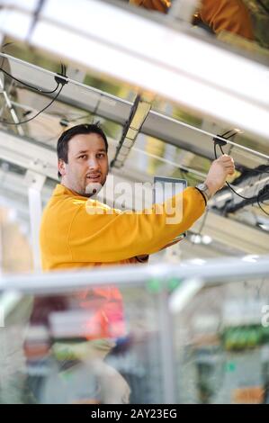 Young expert working at solar panels Stock Photo