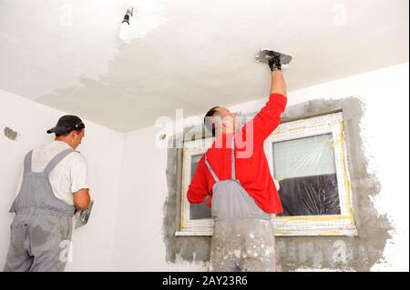 Construction workers painting walls Stock Photo