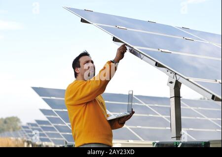 Young expert working at solar panels Stock Photo