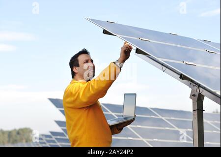 Young expert working at solar panels Stock Photo
