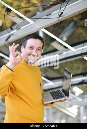Engineer using laptop at factory Stock Photo