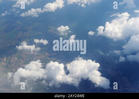 View from airplane window above the clouds Stock Photo