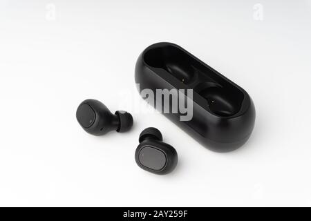 Wireless earbuds or earphones on white background. Copy space and technology concept Stock Photo