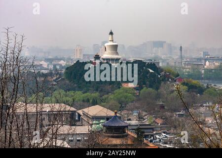 The White Pagoda in the Beihai Park as seen from the Jingshan Hill on a smoggy day, Beijing Stock Photo