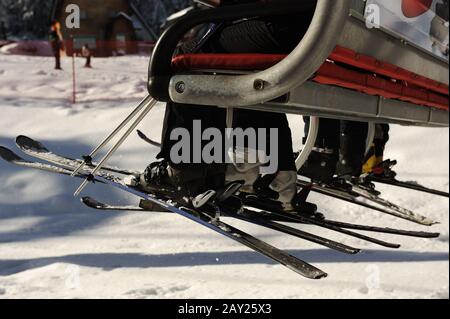 People riding on ski lift. Rear View. No Faces. Copy space. Stock Photo